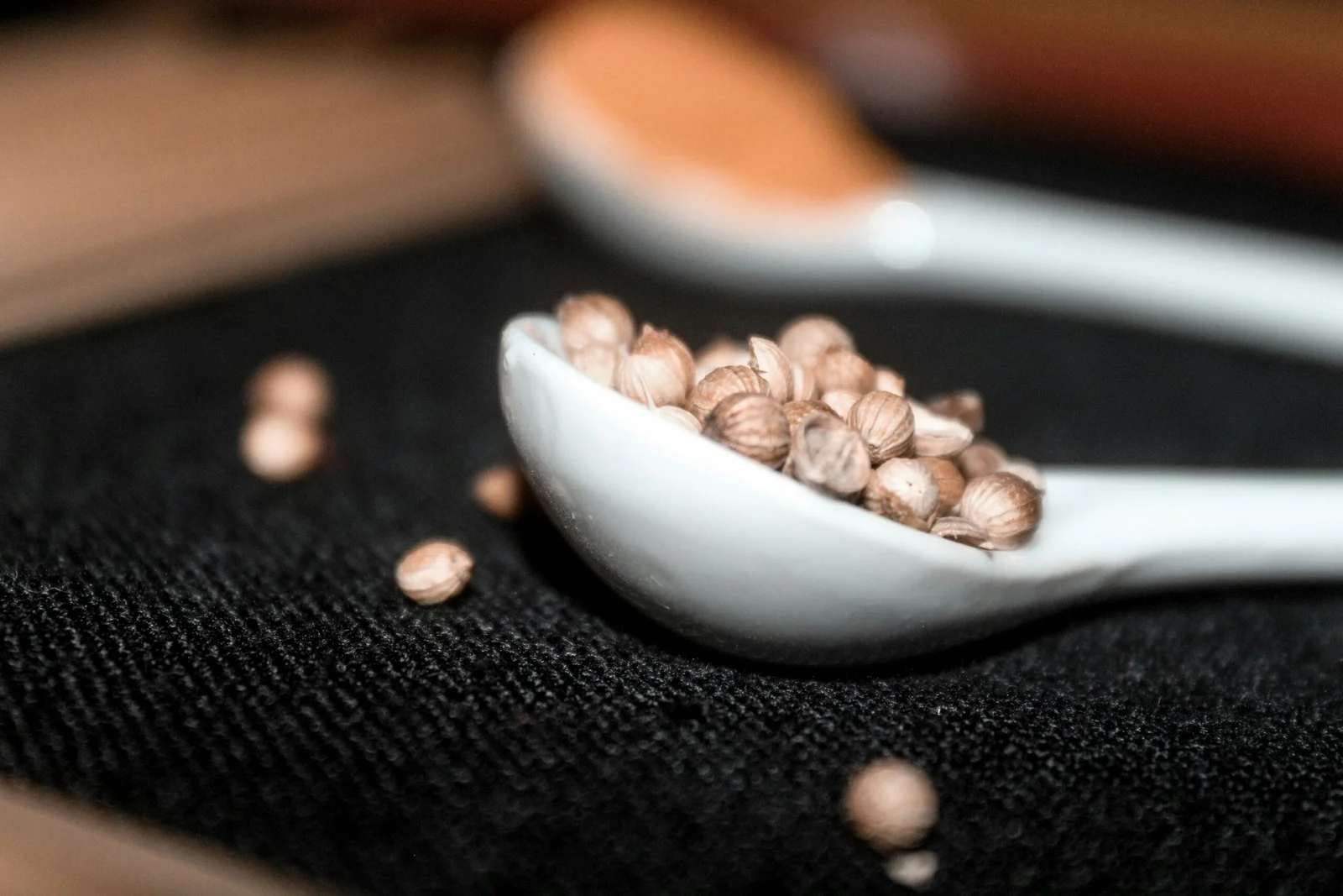 brown and white ceramic bowl on black textile